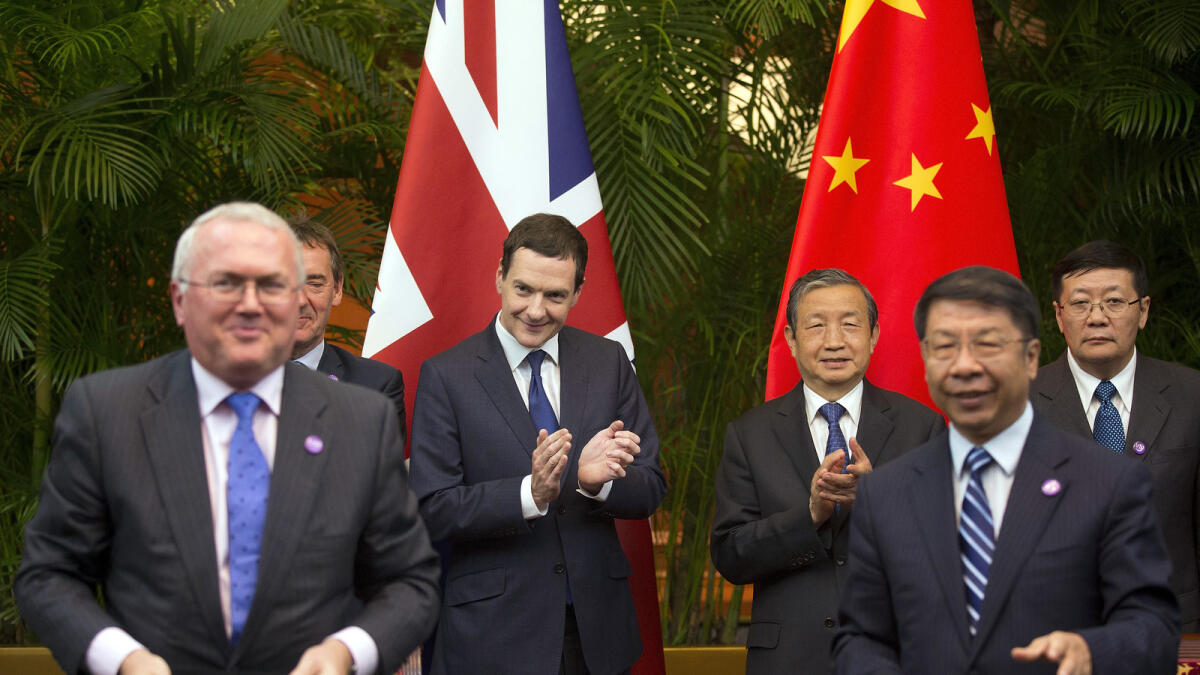 Britain's Chancellor of the Exchequer George Osborne, center left, and Chinese Vice President Ma Kai, center right, applause as they witness a signing ceremony of the 7th China-UK strategic economic dialogue 'Roundtable on Public-Private Partnerships' at Diaoyutai State Guesthouse Monday, Sept. 21, 2015 in Beijing. (AP Photo/Andy Wong, Pool)