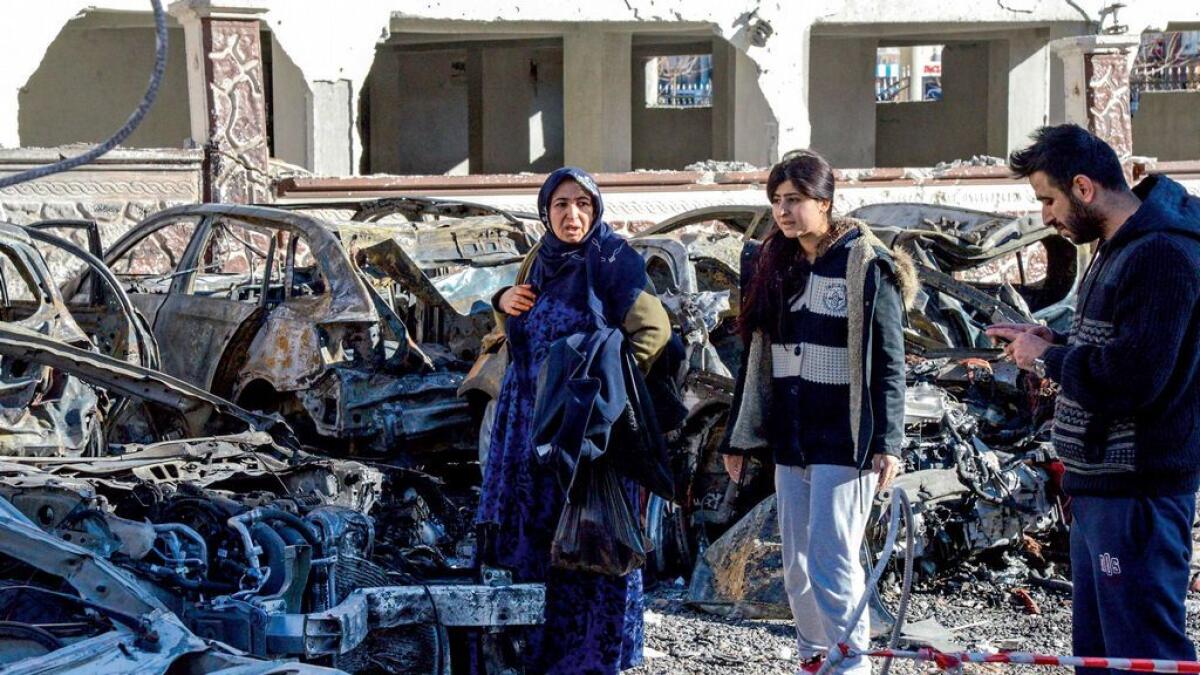 Despite raging on for more than six years, there is no end in sight for war in Syria and parties are going around in circles. In this picture, people walk past damaged cars at the blast site in Sanliurfa. 