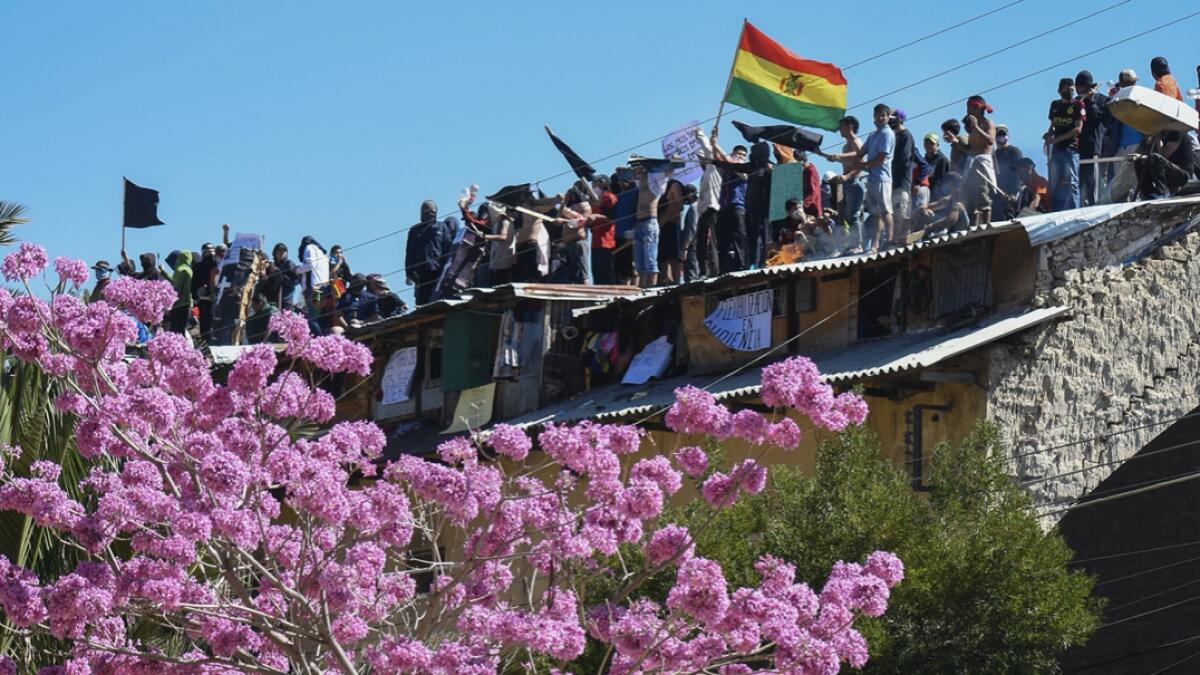 Inmates protest on the roof of a San Sebastian prison, asking for better medical attention amid the pandemic and to be given the results from previously administered Covid-19 tests, in Cochabamba, Bolivia. Photo: AP