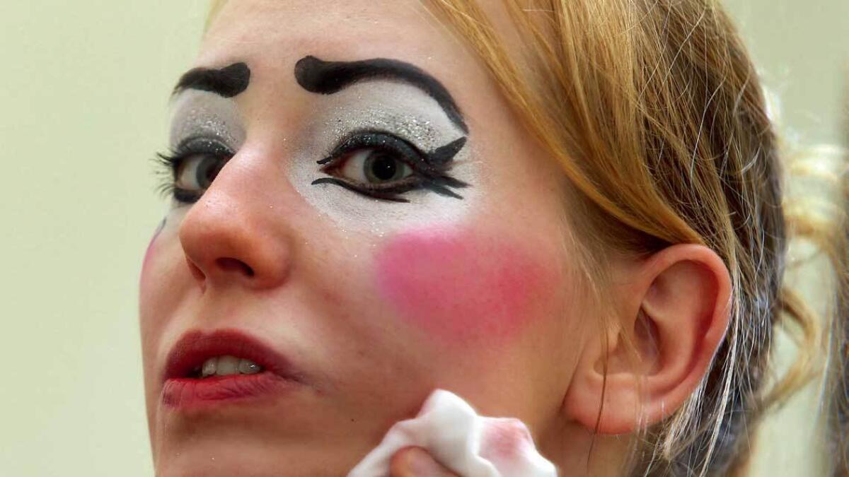 END OF THE DAY ... A clown removes makeup after performing.