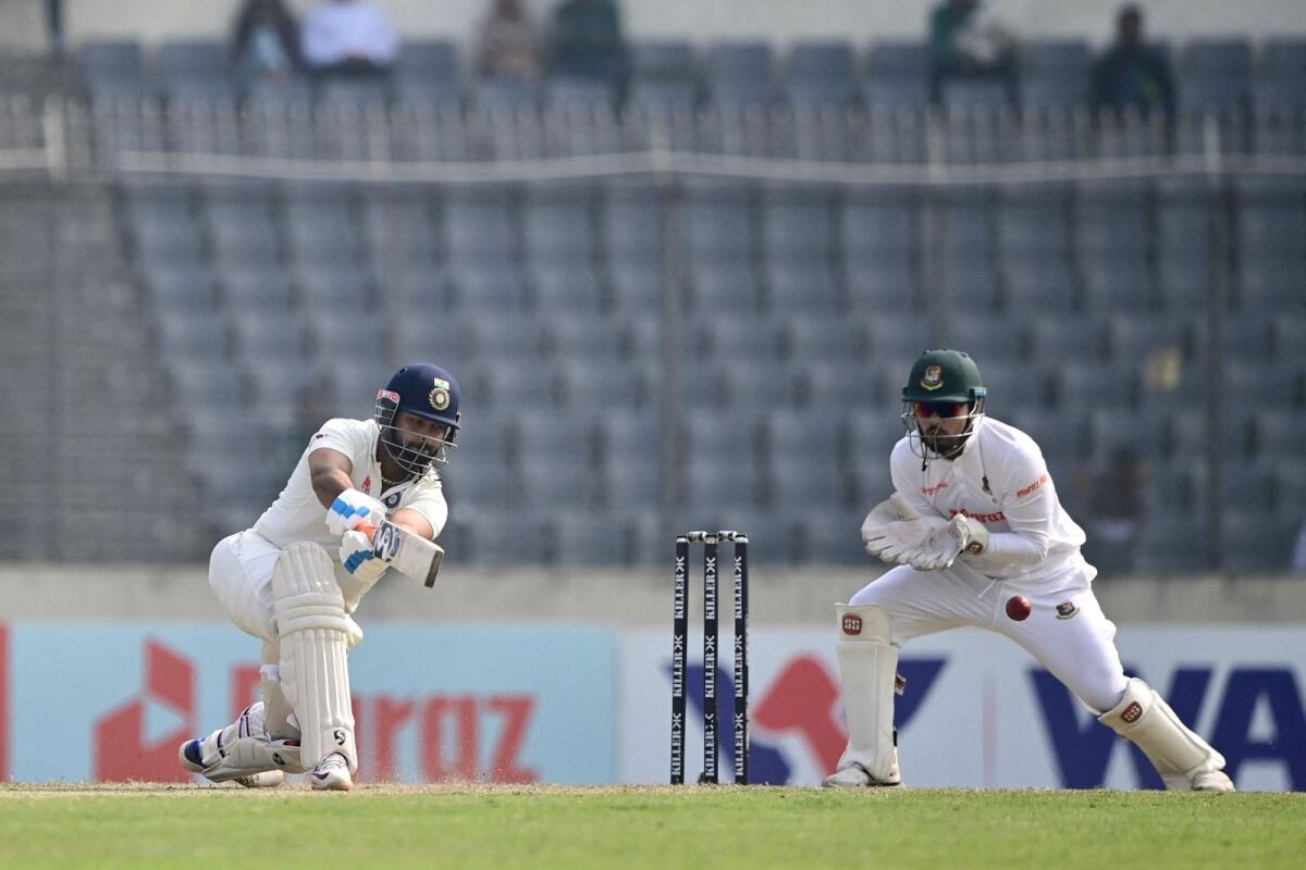 India's Rishabh Pant (left) plays a shot as Bangladesh's Nurul Hasan looks on during the second day of the second Test in Dhaka. (AFP)