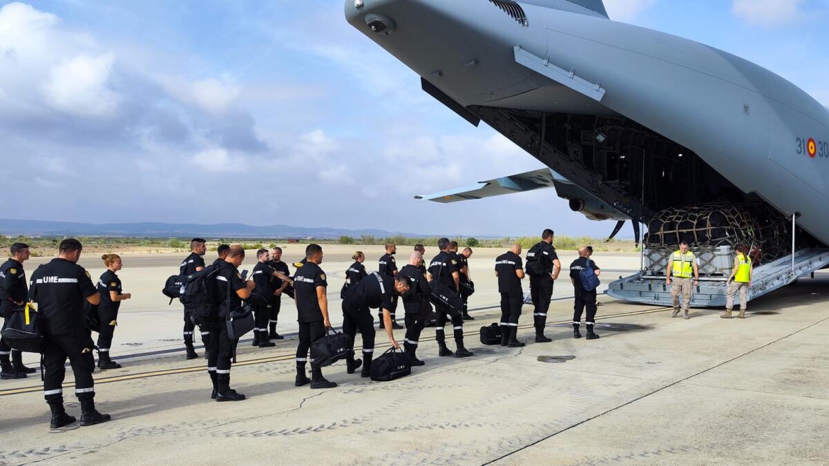 In this photo taken by UME (military emergency unit), a UME military emergency search and rescue unit board a plane at the air base in Zaragoza, Spain. — AP