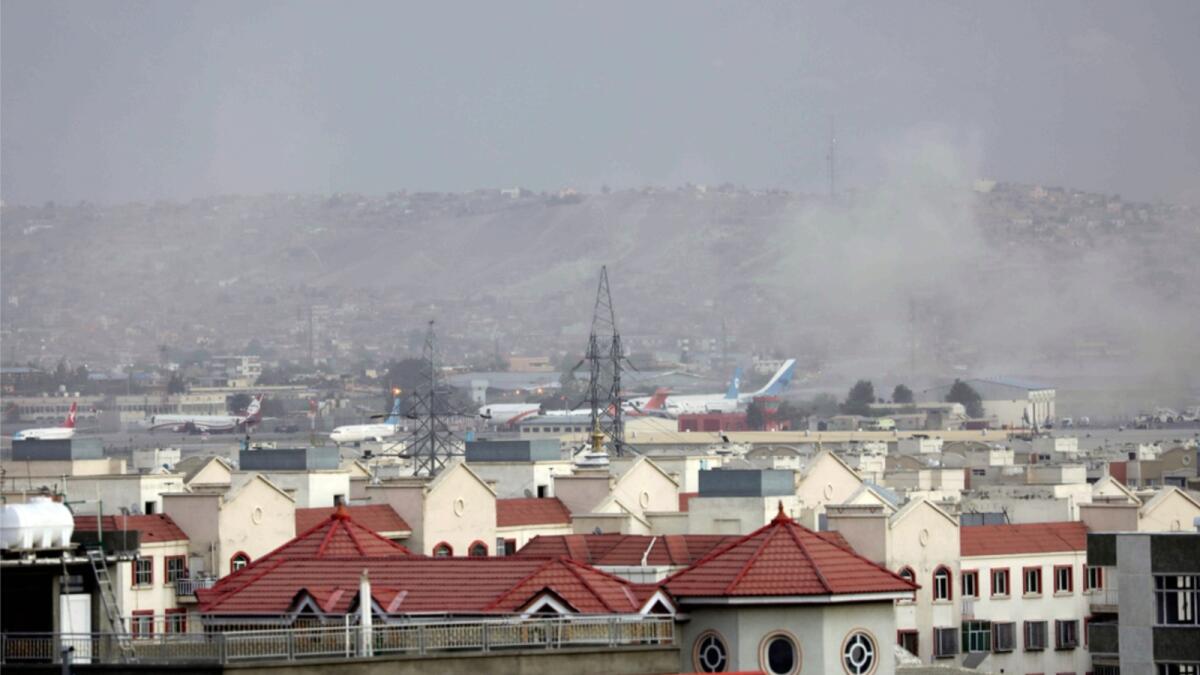 Smoke rises from a deadly explosion outside the airport in Kabul. — AP
