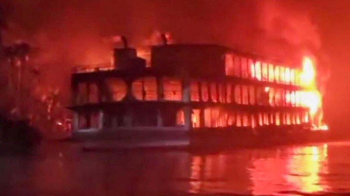 A burning ferry after it caught on fire killing at least 37 people in Jhalkathi, 250 kilometers (160 miles) south of Dhaka, early on December 24, 2021. Photo: AFP