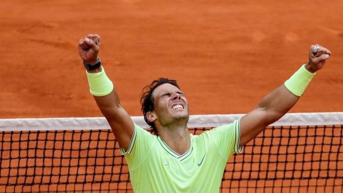 Rafael Nadal celebrates after sweeping an historic 12th Roland Garros title and 18th Grand Slam crown last year. - AFP file