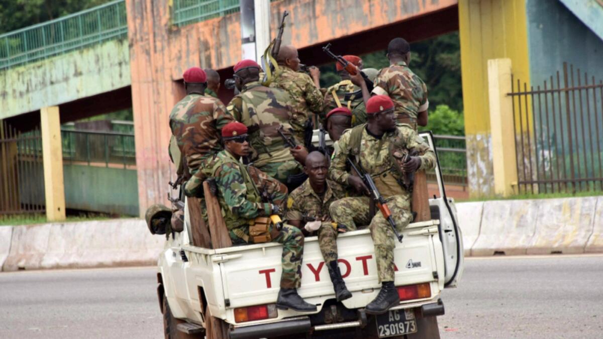 Members of the Armed Forces of Guinea drive through the central neighbourhood of Kaloum in Conakry on September 5. — AFP