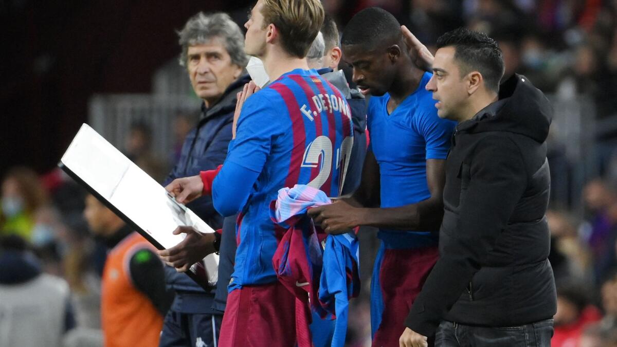 Barcelona coach Xavi (right) rings in the changes during the match against Real Betis. — AFP