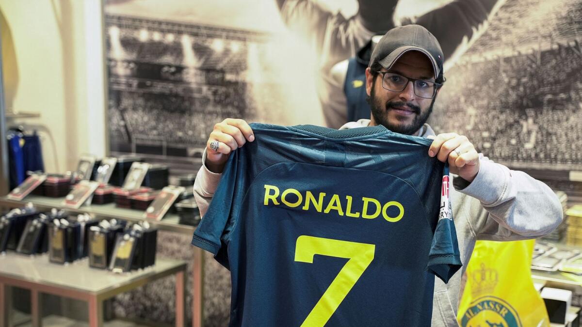 A fan holds up an Al Nassr jersey with Ronaldo's name on the back in Riyadh. — Reuters