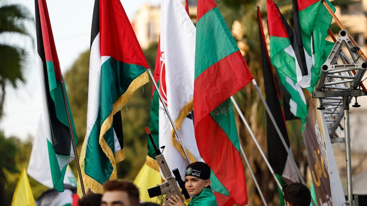 People raise Palestinian flags during a march to show solidarity with the Palestinians of the West Bank and the Gaza Strip, in the southern Lebanese city of Sidon. — AFP
