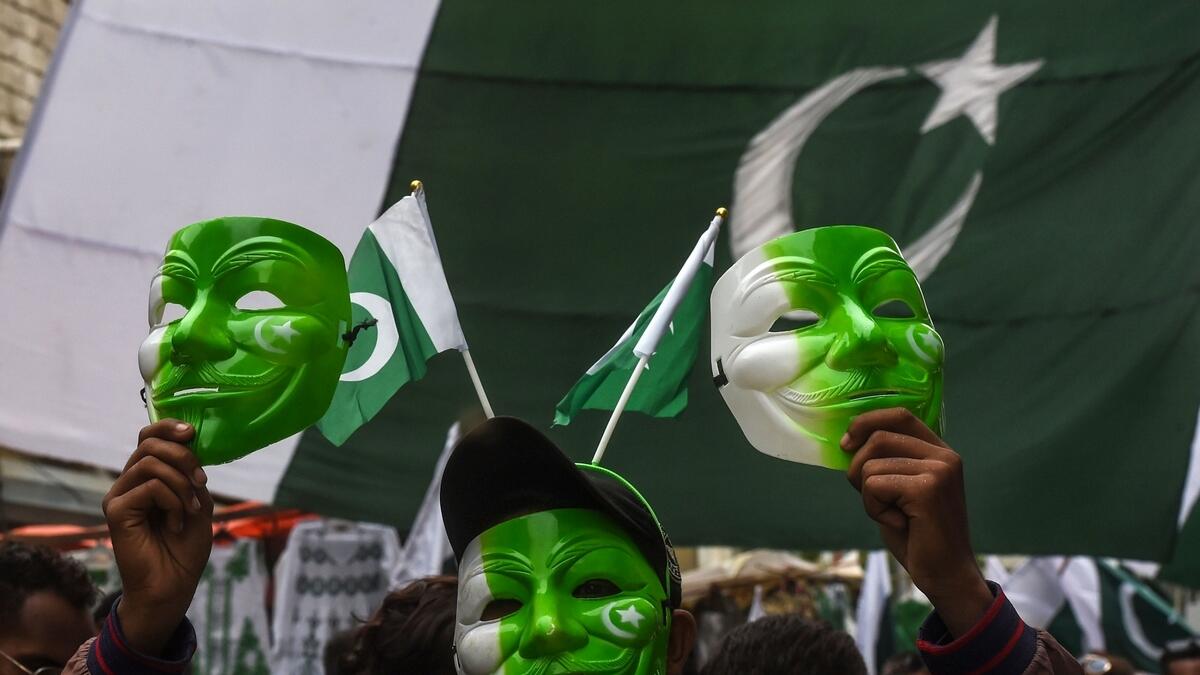 People visit a market to buy national flags, badges and masks ahead of Pakistan Independence Day celebration, in Karachi, Pakistan. AP Photo