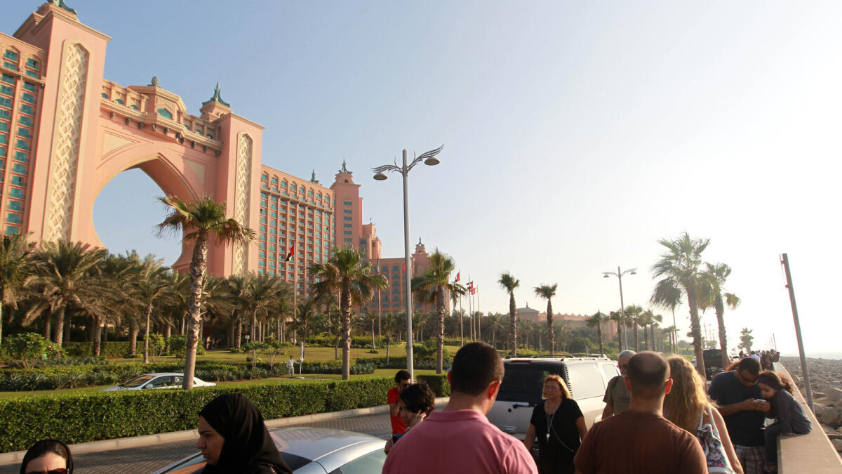 Tourists outside the Atlantis Hotel on the Palm Jumeirah in Dubai. The hospitality’s industry outlook has weakened in recent months due to the geopolitical situation and volatile oil prices. 
