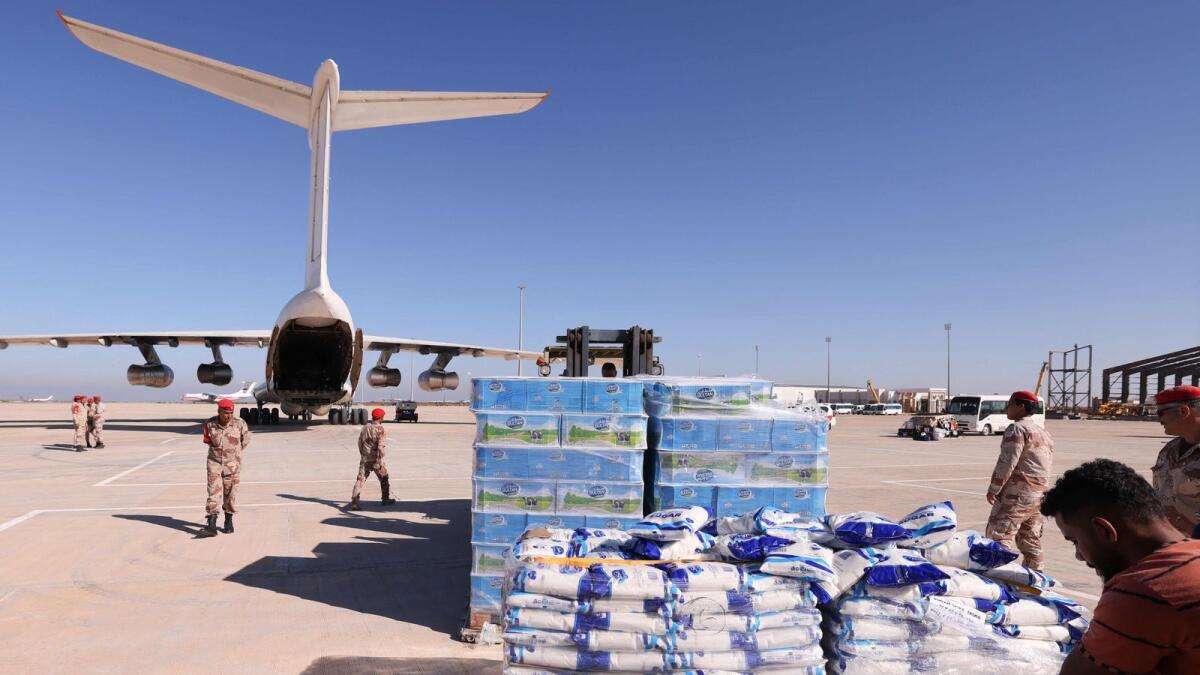 Military personnel supervise the arrival of aid supplied by the UAE for survivors of the floods that submerged Libya's eastern city of Derna, at the airport of Benghazi. — AFP