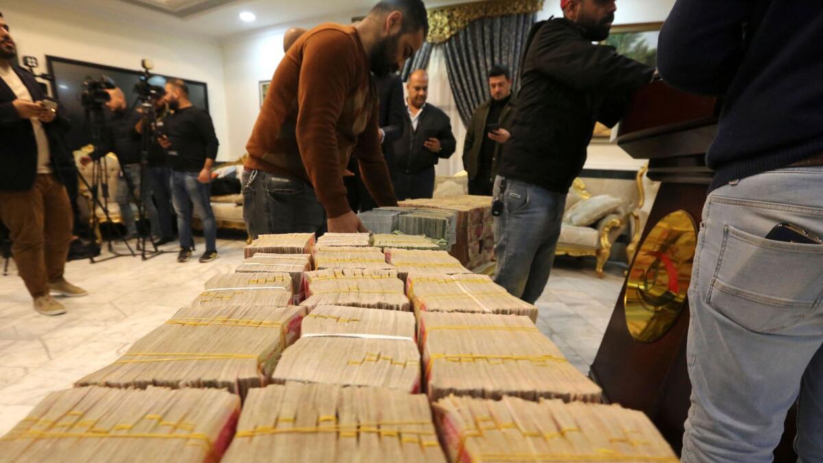 Journalists arrive for a press conference by the head of the Federal Authority of Integrity in Baghdad on Tuesday to announce the recovery of four billion Iraqi dinars, the equivaliant of $2.6 million. — AFP