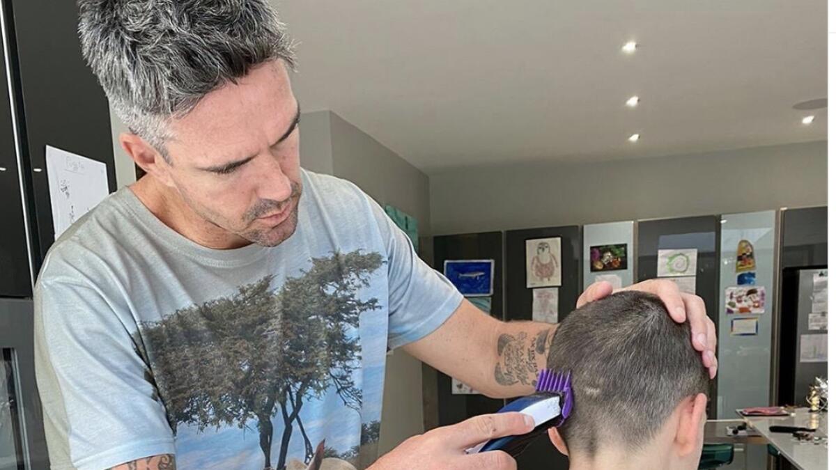 Kevin Pietersen seen giving his son a haircut, what he calls the tennis ball cut.  - Instagram