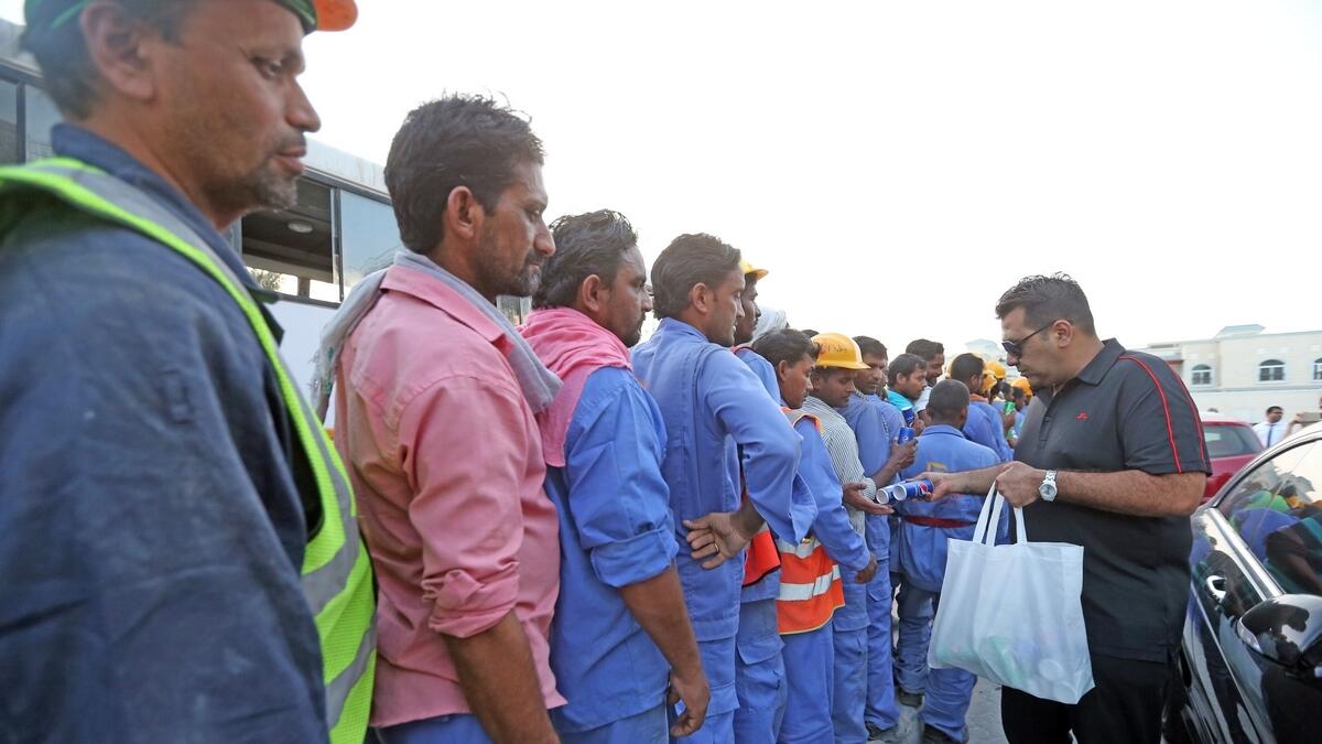Imran Karim distributes food and drinks to workers along the Jumeirah Road in Dubai.— Photo by Dhes Handumon/ Khaleej Times