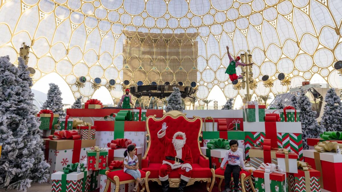 Santa with visitors in the Grotto at Al Wasl, Expo 2020 Dubai.