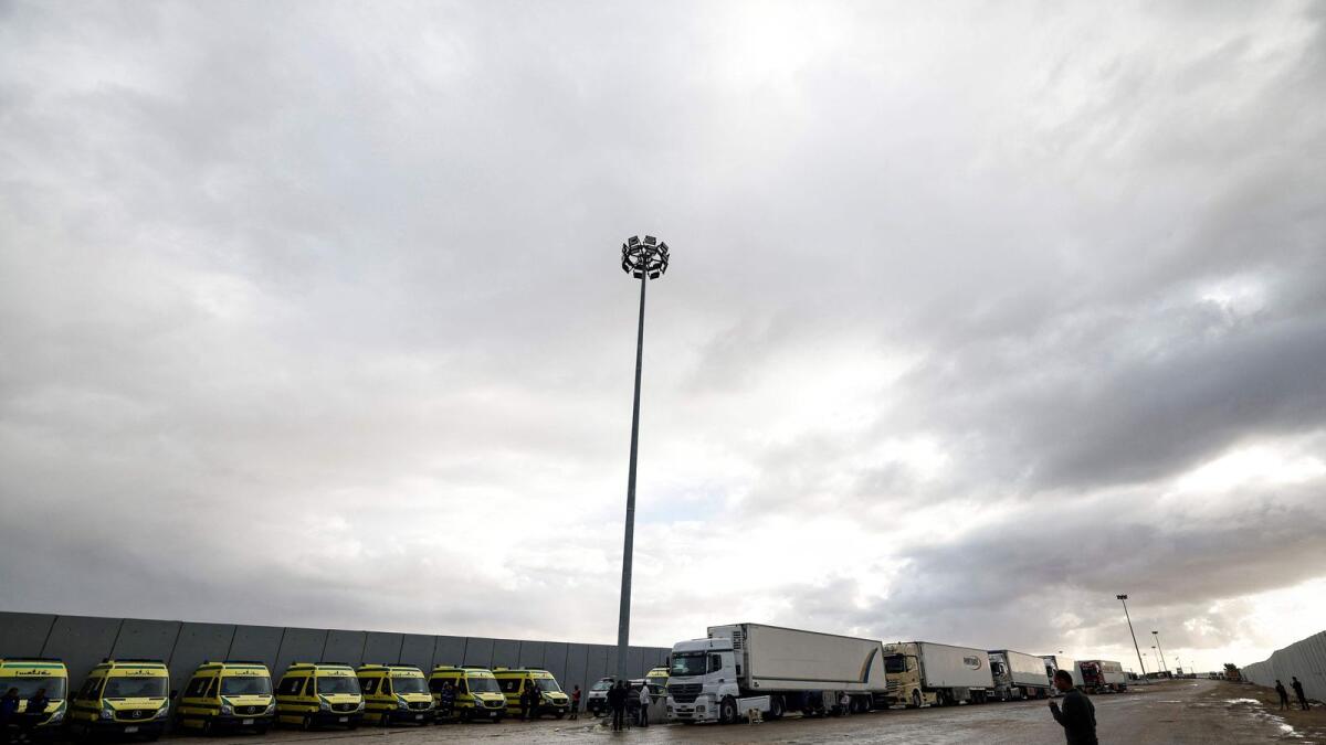 Ambulances and trucks are parked at the Egyptian side of the Rafah border crossing. — AFP file