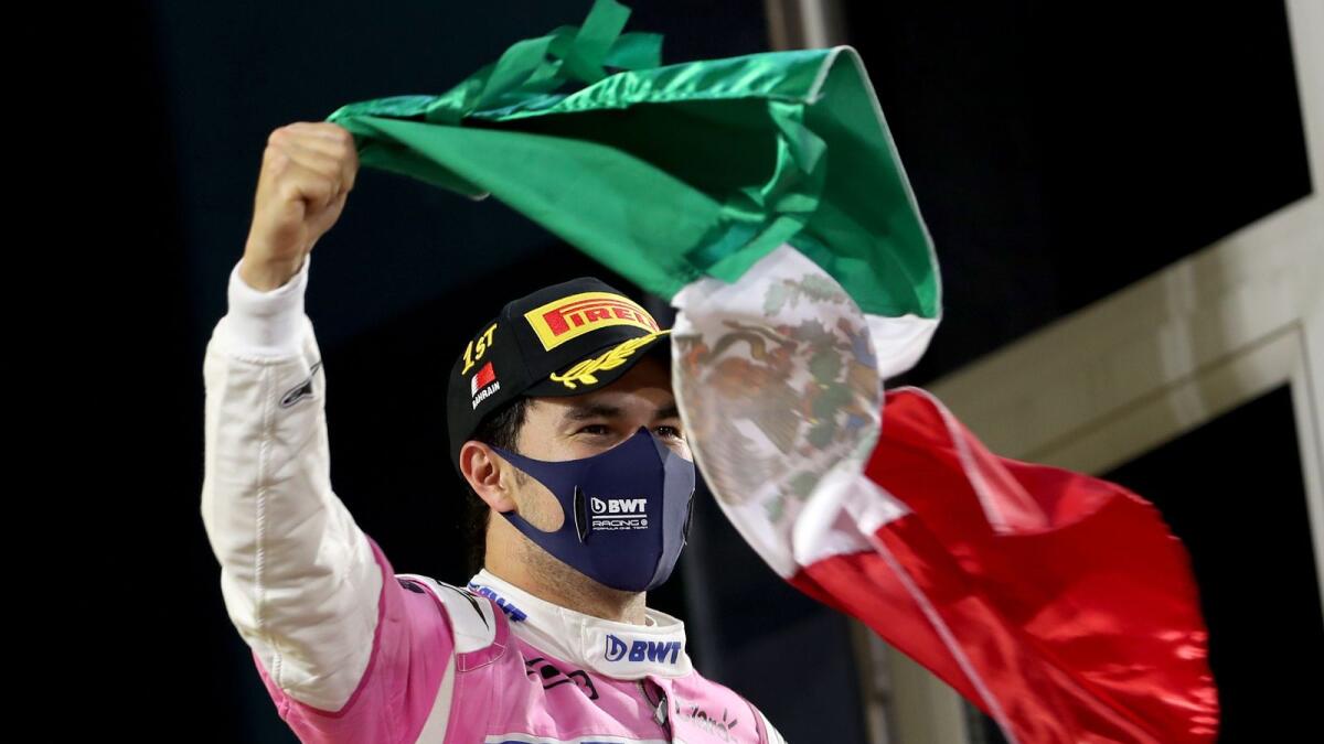Racing Point's Mexican driver Sergio Perez waves the Mexican flag on the podium after winning the Sakhir Formula One Grand Prix in Bahrain. — AFP