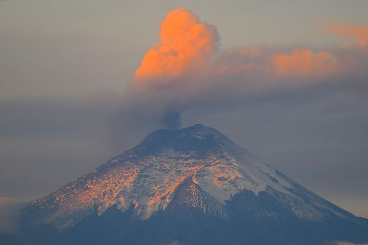 A plume of steam and gas billows from the Cotopaxi volcano as seen from Quito on Tuesday. — AFP