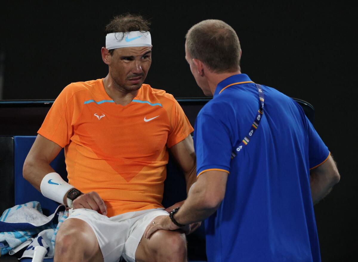 Rafael Nadal receives medical attention after sustaining an injury during his second round match against Mackenzie Mcdonald at the Australian Open in January. — Reuters file