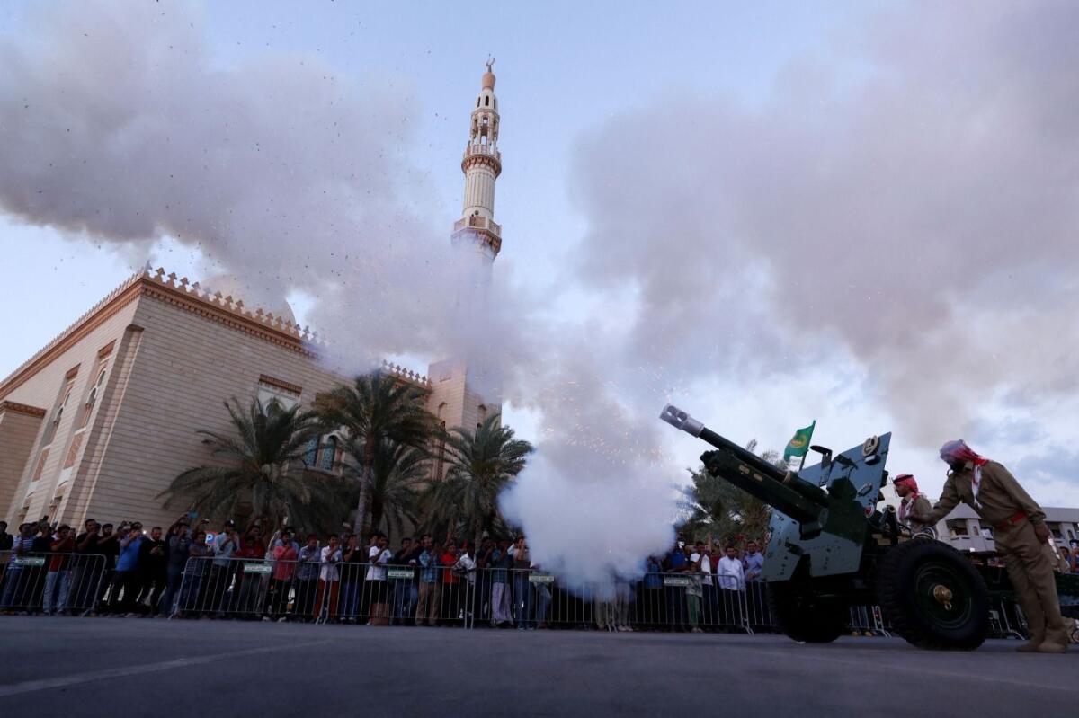 Dubai Police officers fire a cannon to mark the end of fasting on the first day of Ramadan in Dubai, United Arab Emirates, March 23, 2023. Photo: Reuters