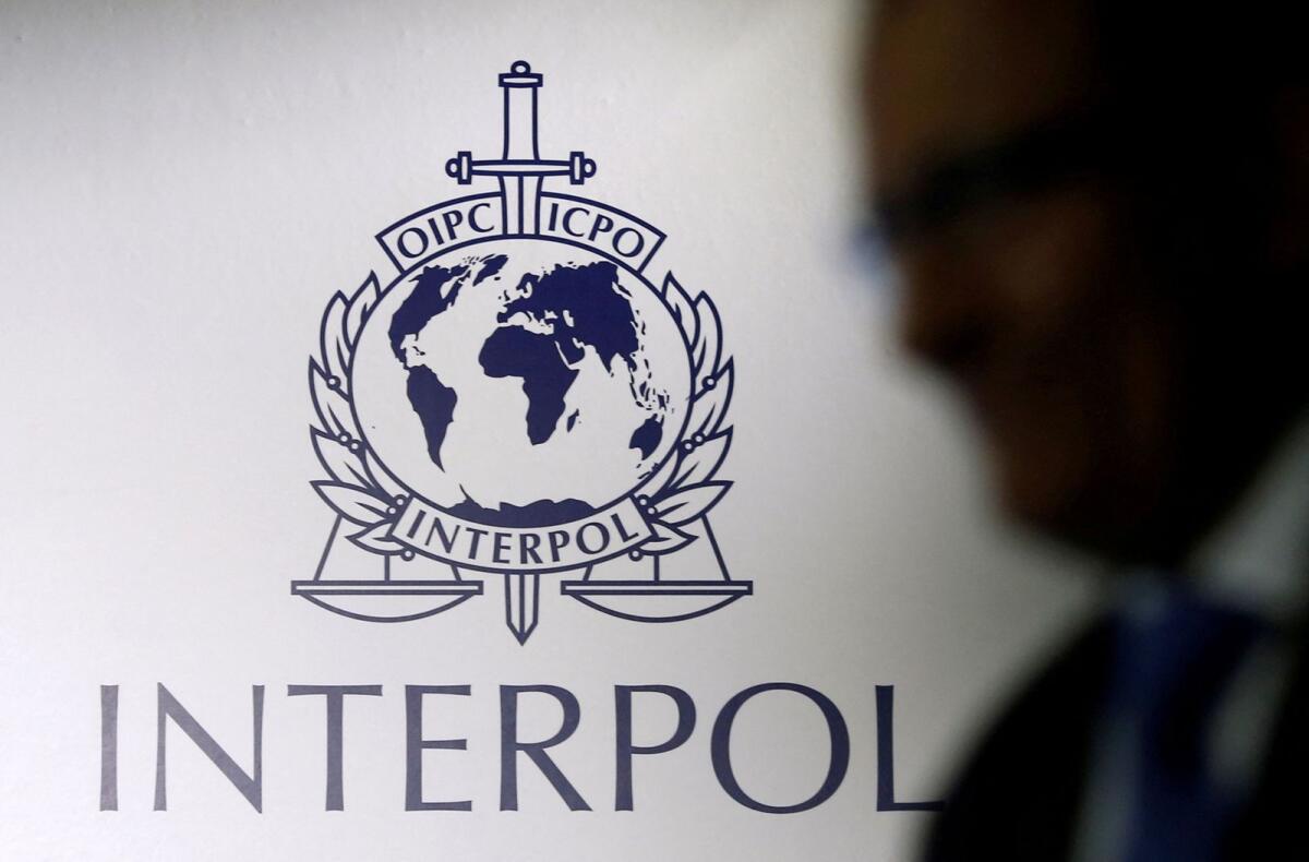 A man passes an Interpol logo during the handing over ceremony of the new premises for Interpol's Global Complex for Innovation, a research and development facility, in Singapore. — Reuters file