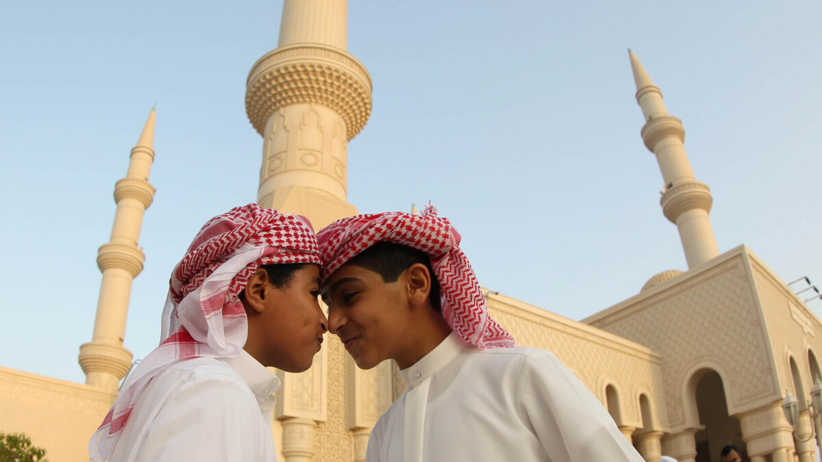 TRADITION ALL THE WAY ... Young Emirati boys greet each other at the Shaikh Mohammed Bin Zayed Mosque in Abu Dhabi. - Photo by Ryan Lim/ Khaleej Times