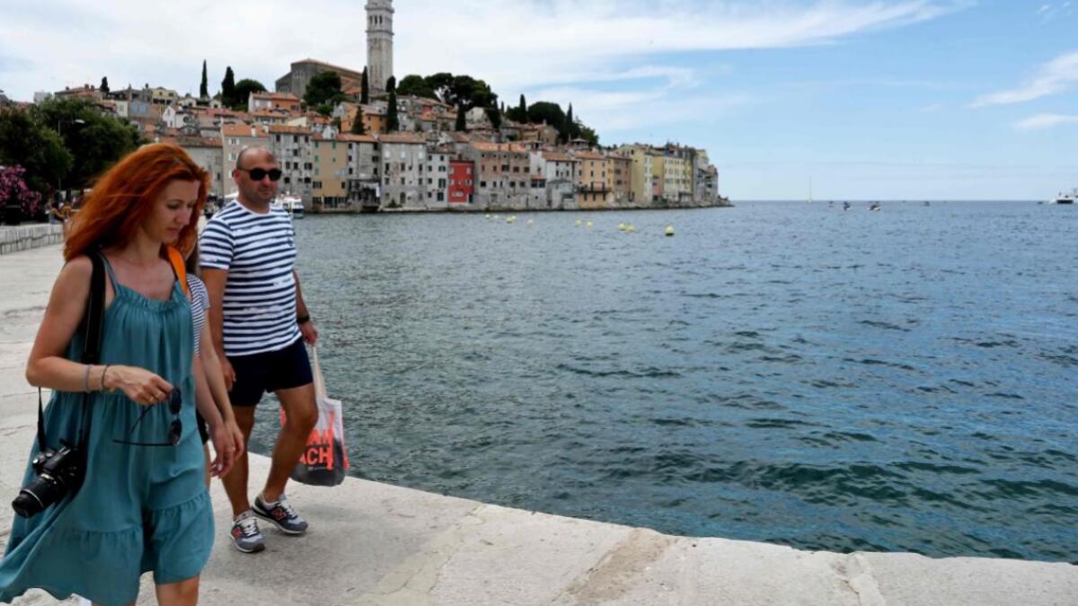 Tourists stroll in downtown Rovinj, on the Istrian peninsula in the Adriatic Sea. Tourists start arriving on Croatia's northern Adriatic coast as Europe opens the borders and eases lockdown measures taken to curb the spread of the Covid-19 pandemic (novel coronavirus).  Photo: AFP