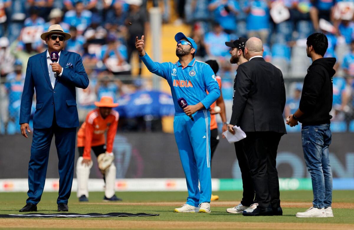 India's Rohit Sharma in action during the coin toss as New Zealand's Kane Williamson looks on. Photo: Reuters