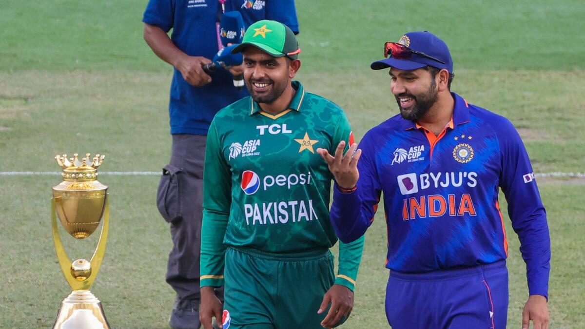 Pakistan skipper Babar Azam (left) with Indian captain Rohit Sharma during the DP World Asia Cup in Dubai. — AFP
