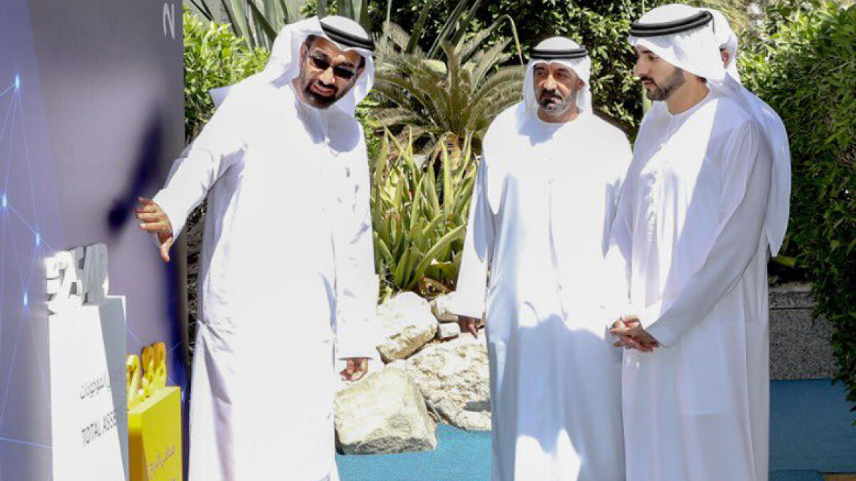 GET UPDATED: Sheikh Hamdan bin Mohammed bin Rashid Al Maktoum and Sheikh Ahmed bin Saeed Al Maktoum during a visit to  Emirates NBD's head office in Dubai on Tuesday. - Supplied  photo