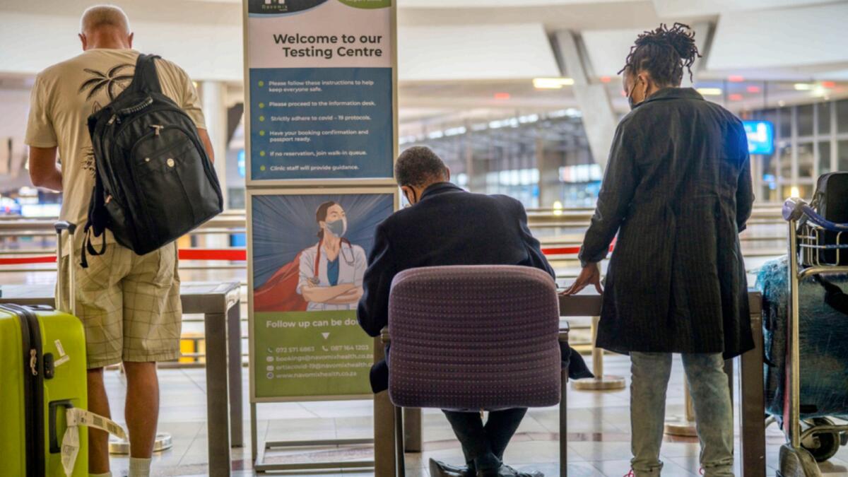 People lineup to get tested for Covid at OR Tambo's airport in Johannesburg, South Africa'. — AP