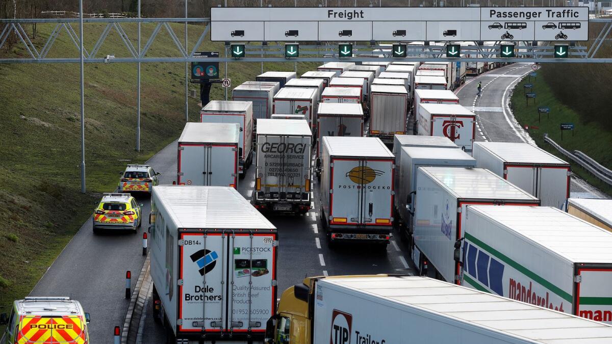 Freight vehicles line up prior to boarding a train to France via the Channel Tunnel, amid the coronavirus disease (COVID-19) outbreak, in Folkestone, Britain, December 20, 2020.