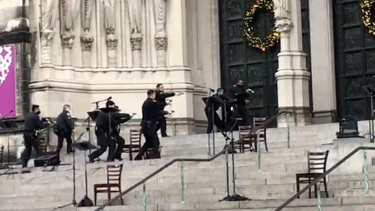 New York police officers move in on the scene of a shooting at the Cathedral Church of St. John the Divine.  - AP