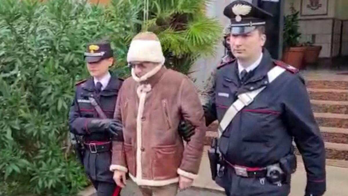 A video screengrab shows Matteo Messina Denaro, the country's most wanted mafia boss, being escorted out of a Carabinieri police station after his arrest. Photo: Retuers