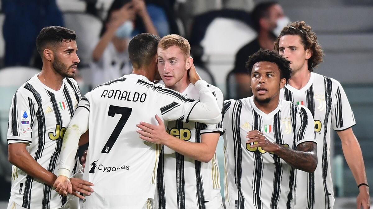 Juventus' Cristiano Ronaldo (second left) embraces Dejan Kulusevski after Kulusevski opened the scoring