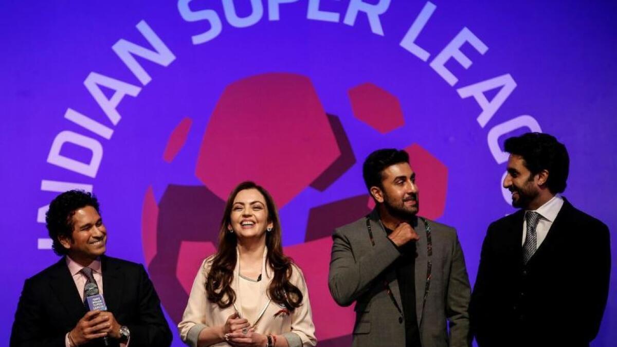 Bollywood actors and co-owners of football clubs, Abhishek Bachhan (right) and Ranbir Kapoor (second right), Nita Ambani, businesswoman and promoter of the Indian Super League, and cricketer and co-owner of the Kerala Blasters Sachin Tendulkar (left) during the emblem-unveiling ceremony of Indian Super League in Mumbai in August, 2014. (Reuters)