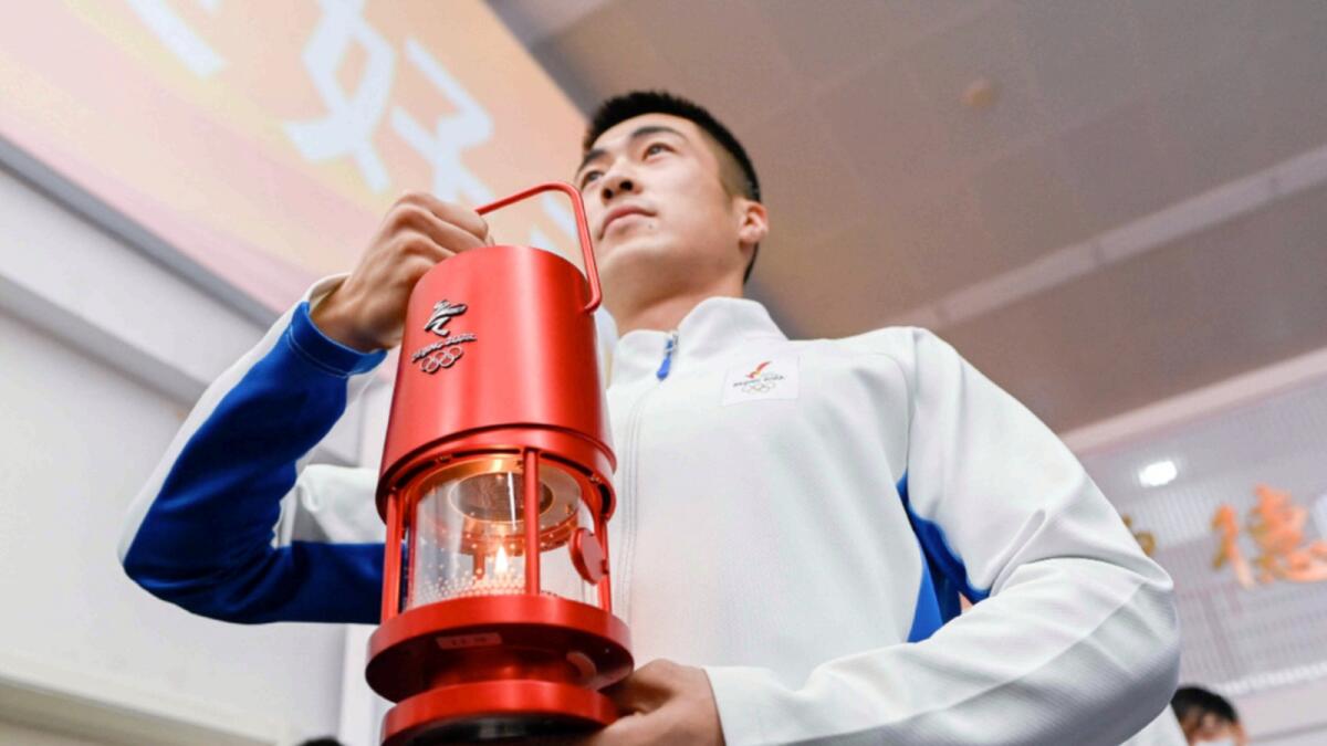 The flame of the Beijing 2022 Winter Olympic Games is displayed during an exhibition tour at the Beijing University of Posts and Telecommunications in Beijing. — AFP