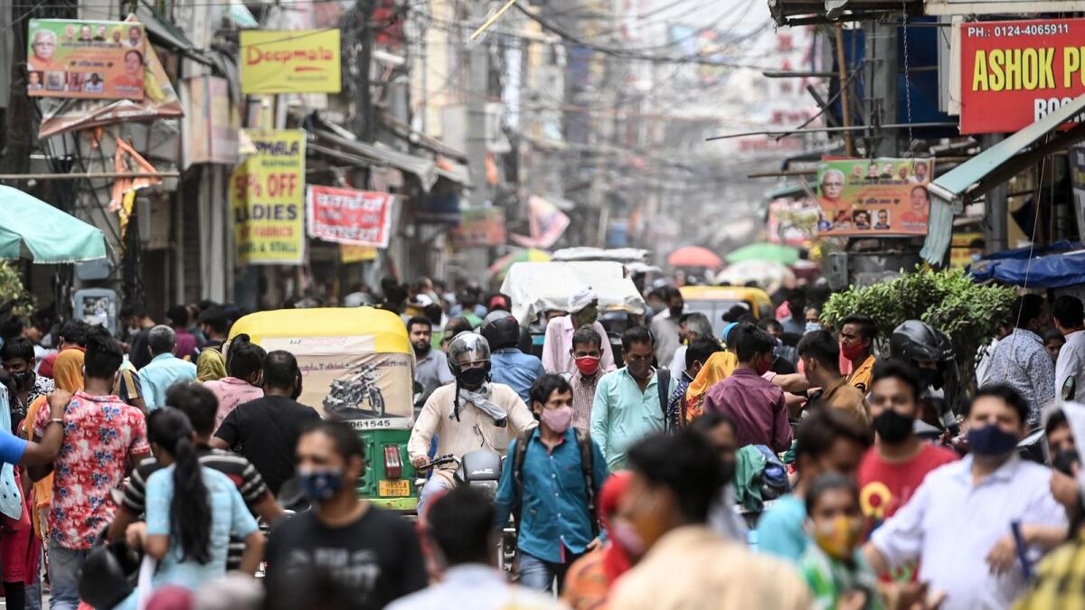 People shop at a market in India. Photo: AFP