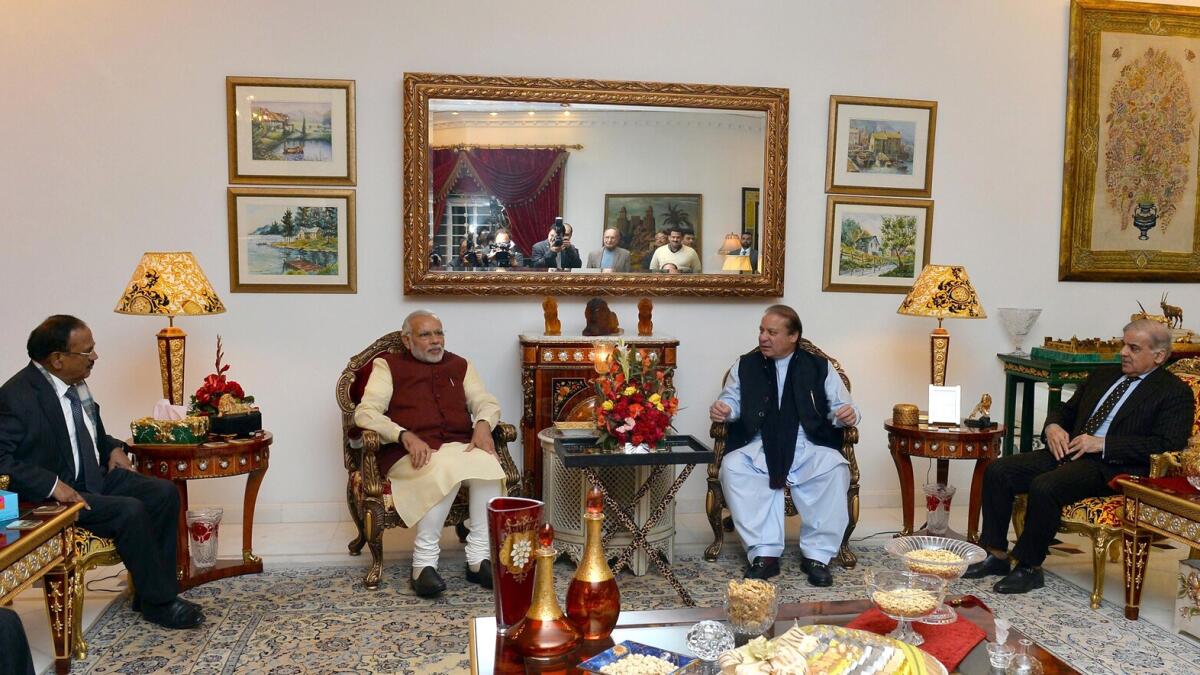 In this photograph released by the Press Information Bureau (PIB) on December 25, 2015, Indian Prime Minister, Narendra Modi (CL) and Pakistan Prime Minister, Nawaz Sharif (CR) look on during a meeting in Lahore. AFP PHOTO / PIB