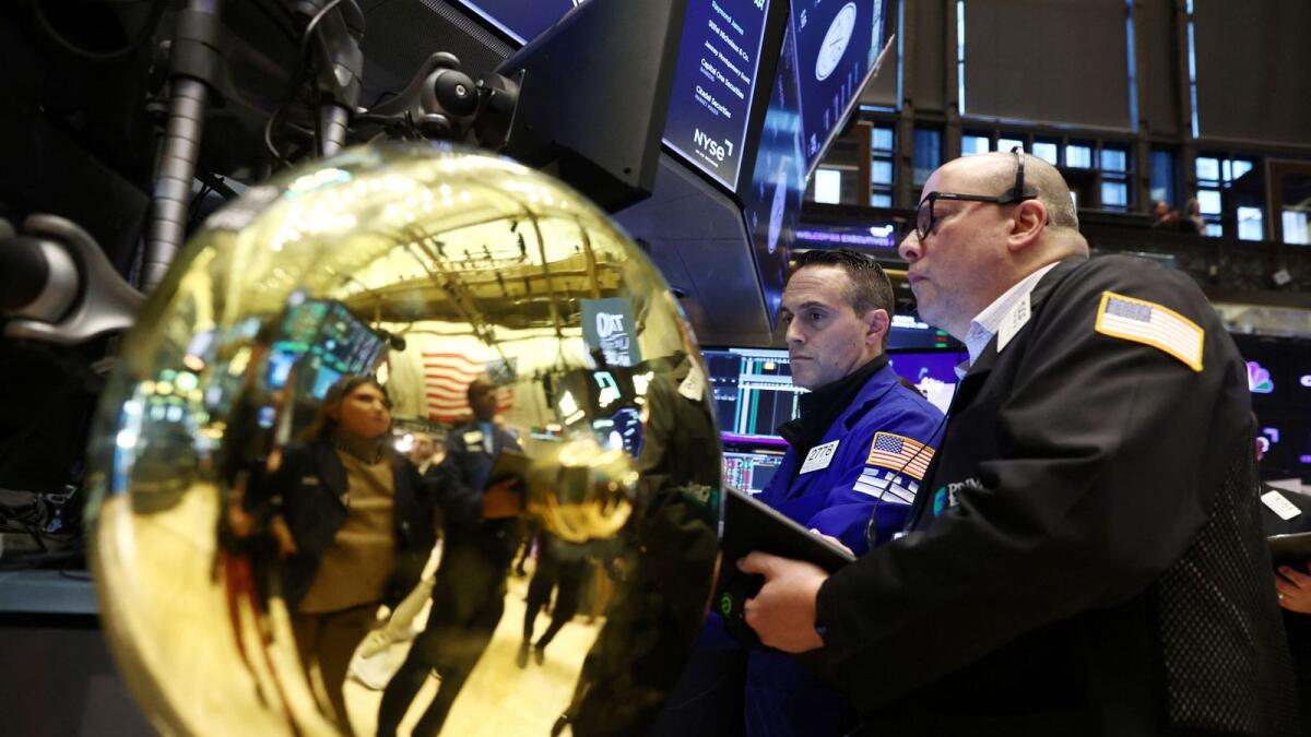 Traders work on the trading floor at the New York Stock Exchange on Friday. - Reuters