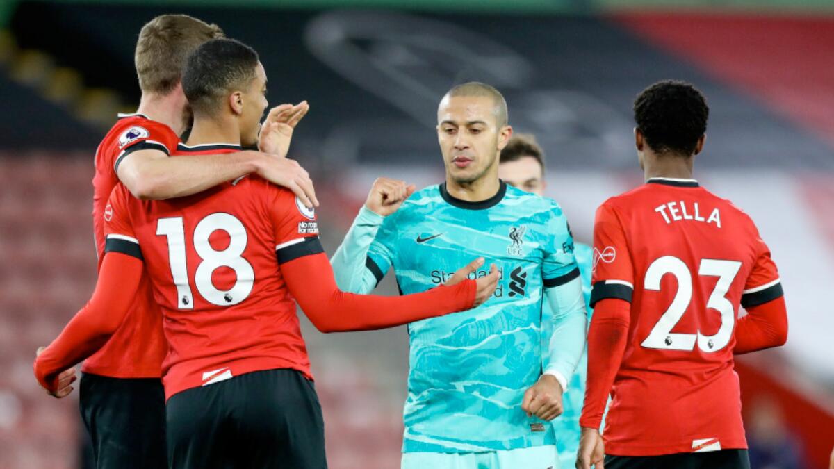 Liverpool's Thiago Alcantara (centre) congratulates Southampton's Jan Bednarek (left) Yan Valery and Nathan Tella (right) following their Premier League match on Monday. (AP)
