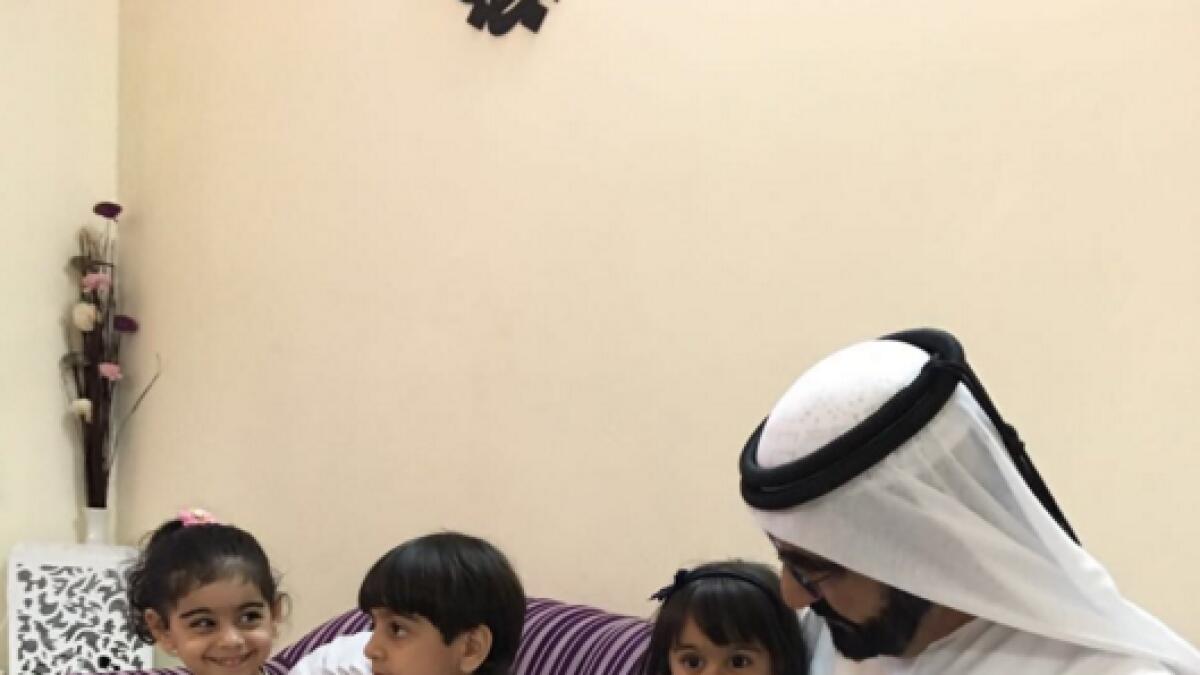 Shaikh Mohammed talks to Muhra Al Shehi as her siblings Abdullah and Asma look on during an unannounced visit by the Dubai Ruler at their residence in Sharjah on Friday.  — Twitter
