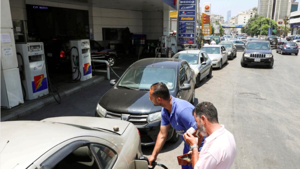 Cars queue up at a petrol pump in Lebanon. — Reuters file