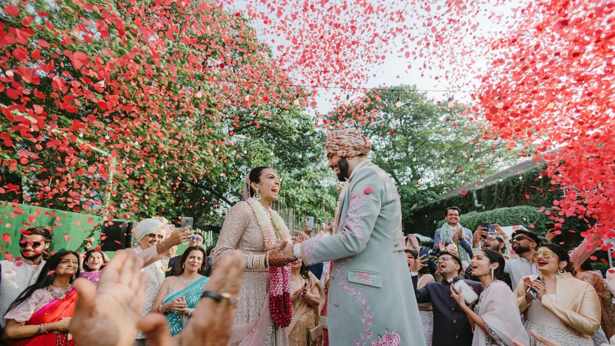 In an undated image provided by House on the Clouds, at a February wedding in Mumbai, India, a crowd of guests cheered a couple during their varmala ceremony, or garland exchange.  (House on the Clouds via The New York Times)