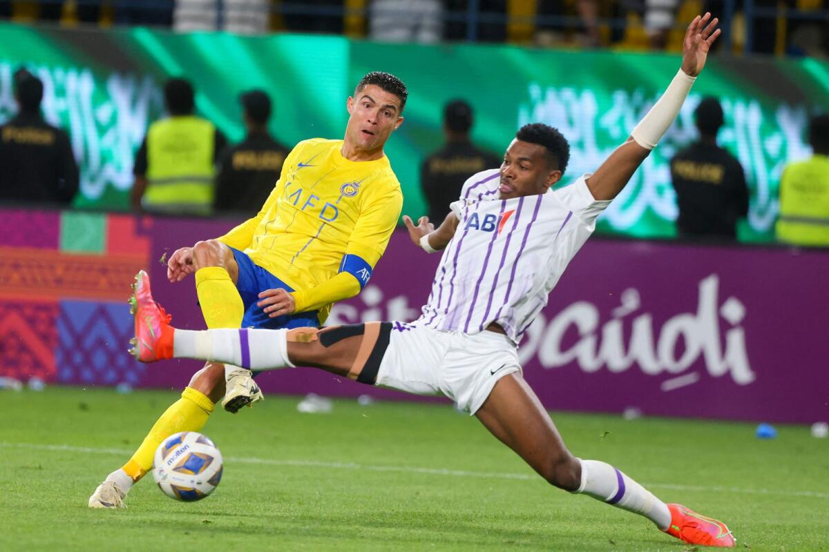 Al Ain's Emirati defender Saeed Juma fights for the ball with Al Nassr's Portuguese forward Cristiano Ronaldo during the match at Al-Awal Park Stadium in Riyadh. — AFP