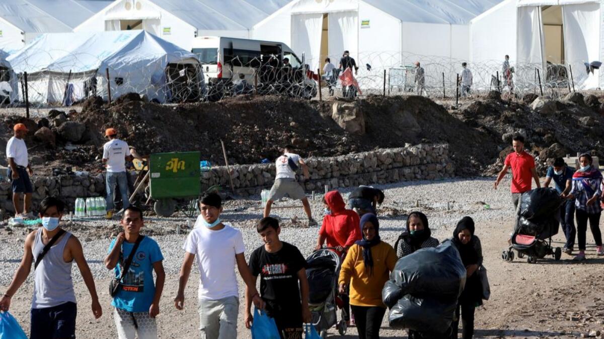 Migrants make their way in the Kara Tepe camp in Greece. – Reuters