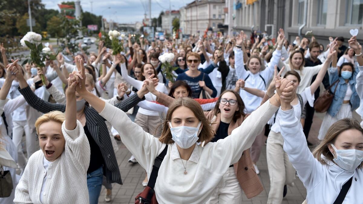 Women dressed in white clothes hold hands as they protest against police violence during recent rallies of opposition supporters, who accuse strongman Alexander Lukashenko of falsifying the polls in the presidential election, in Minsk. Photo: AFP