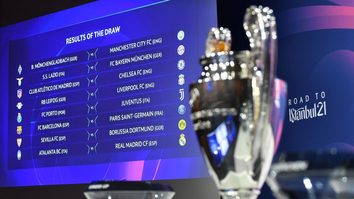 This handout photograph shows the screen displaying the results by the trophy after the draw for the round of 16 of the UEFA Champions League tournament at the UEFA headquarters in Nyon. — FP