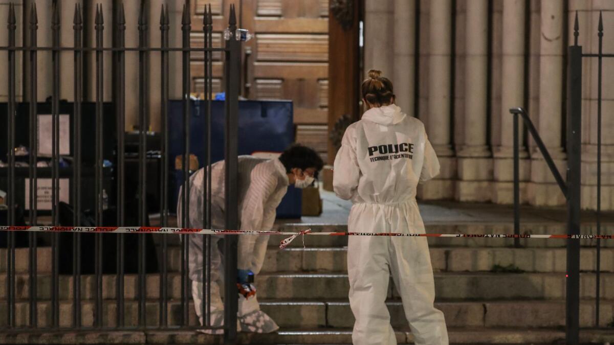 Forensic police work outside the Notre-Dame de l'Assomption Basilica in Nice on October 29, 2020 after a knife-wielding man kills three people in the church, slitting the throat of at least one of them, in what officials are treating as the latest jihadist attack to rock the country. (